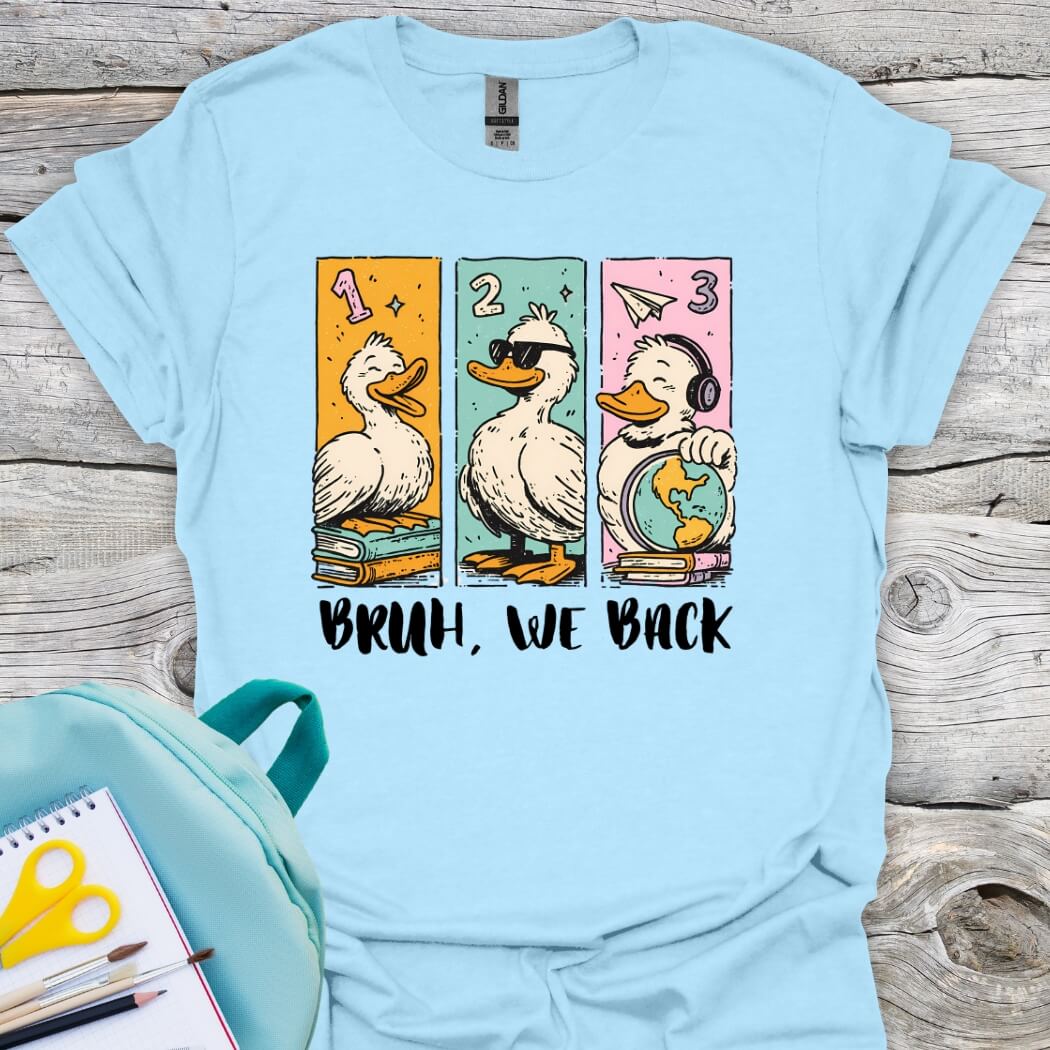 Lightblue t-shirt with cartoon ducks and bruh, we back text