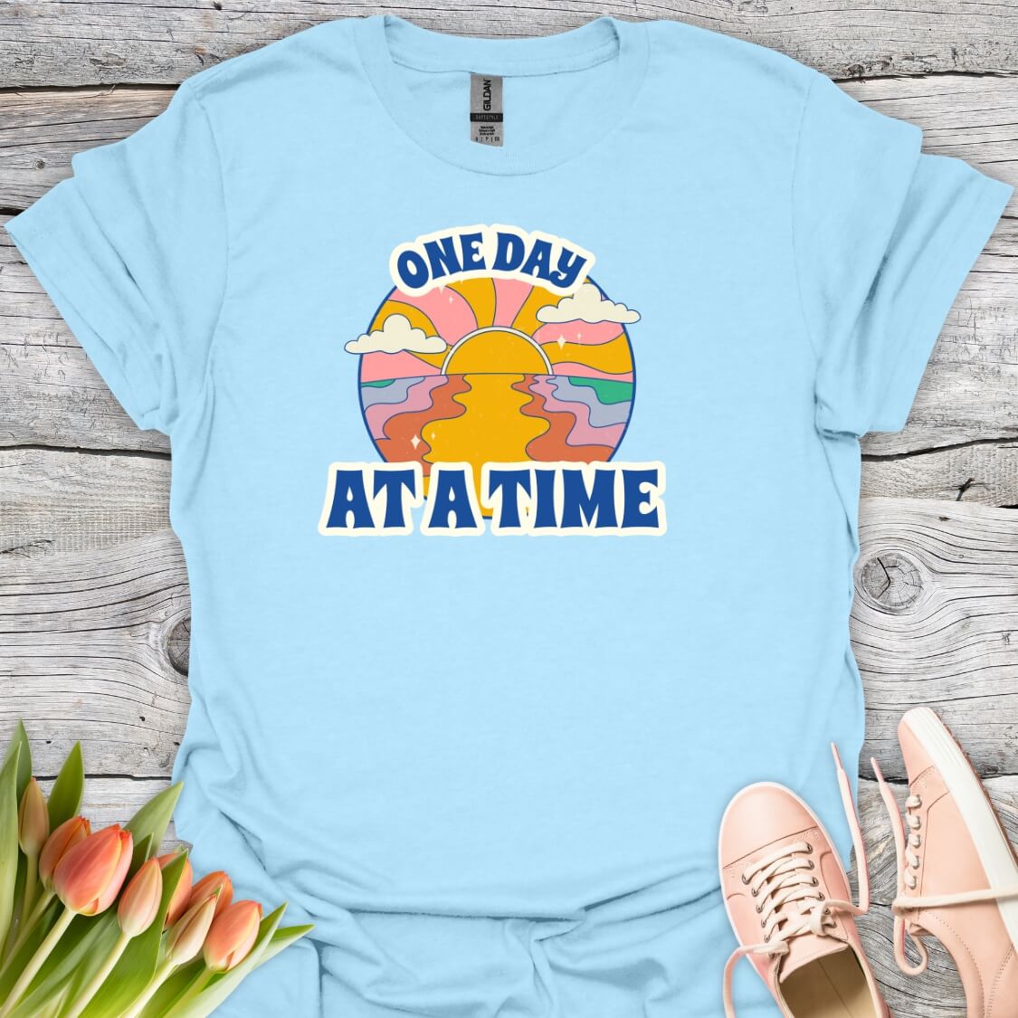 Lightblue t-shirt with 'One Day At A Time' graphic design