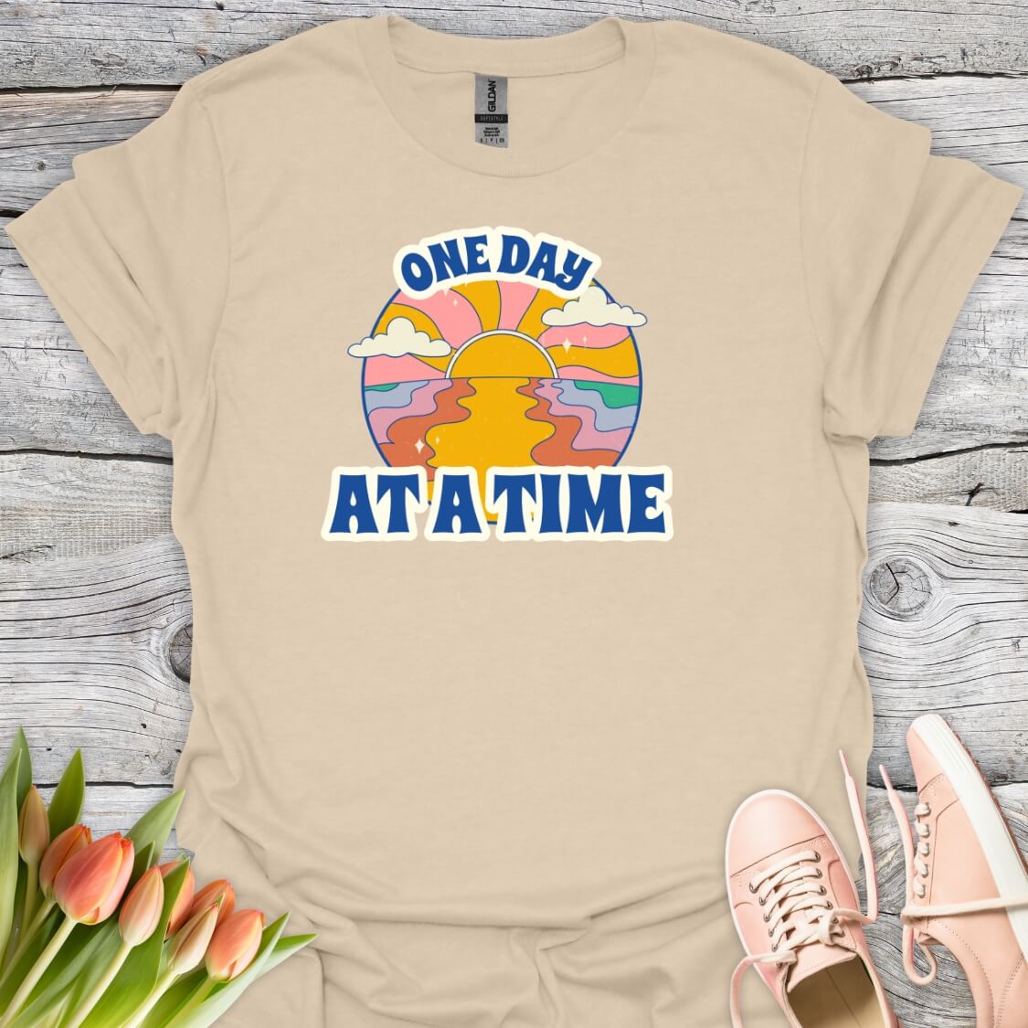 Sand t-shirt with 'One Day At A Time' graphic design