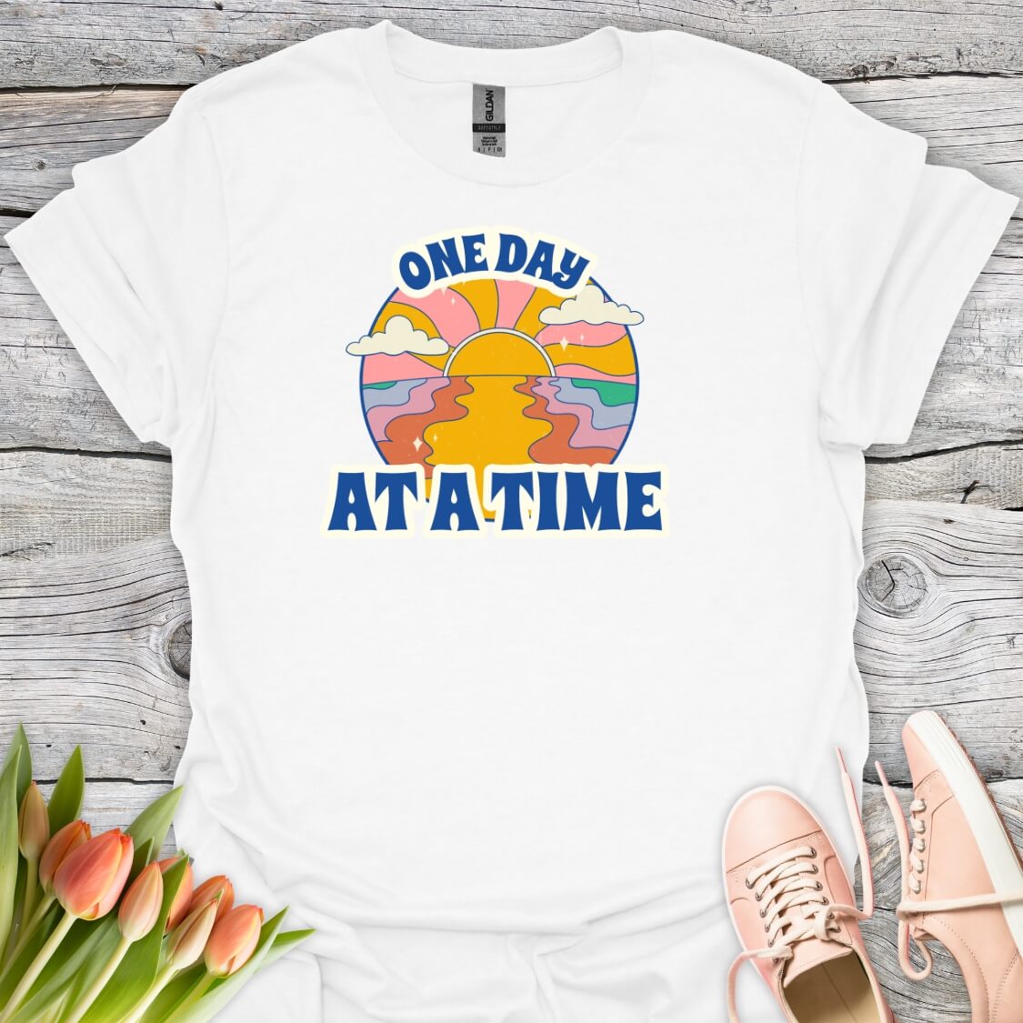 White t-shirt with 'One Day At A Time' graphic design