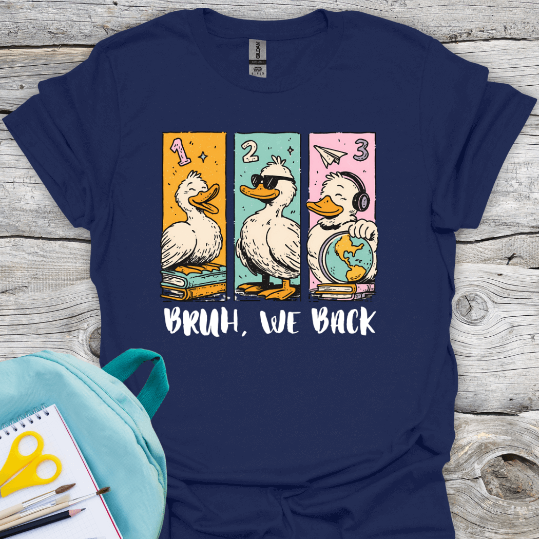 Navy blue t-shirt with duck-themed graphic and 'BRUH, WE BACK' text on a wooden surface.